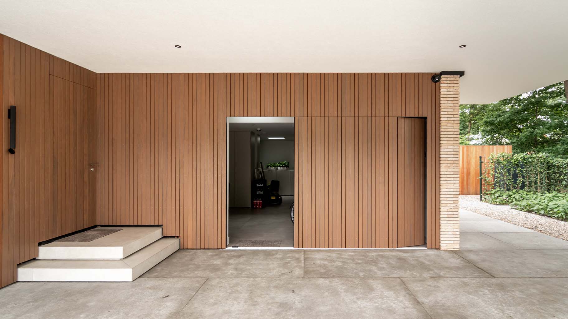 Side sliding garage door made of Fraké wood