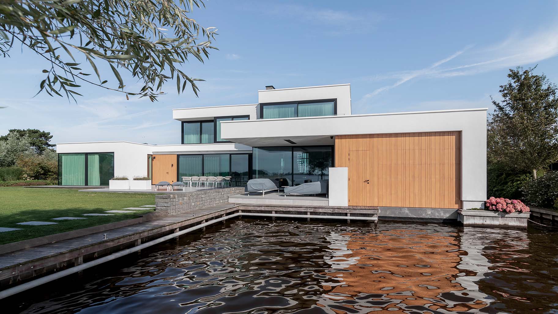 Bespoke garage door for a boathouse at a waterside villa