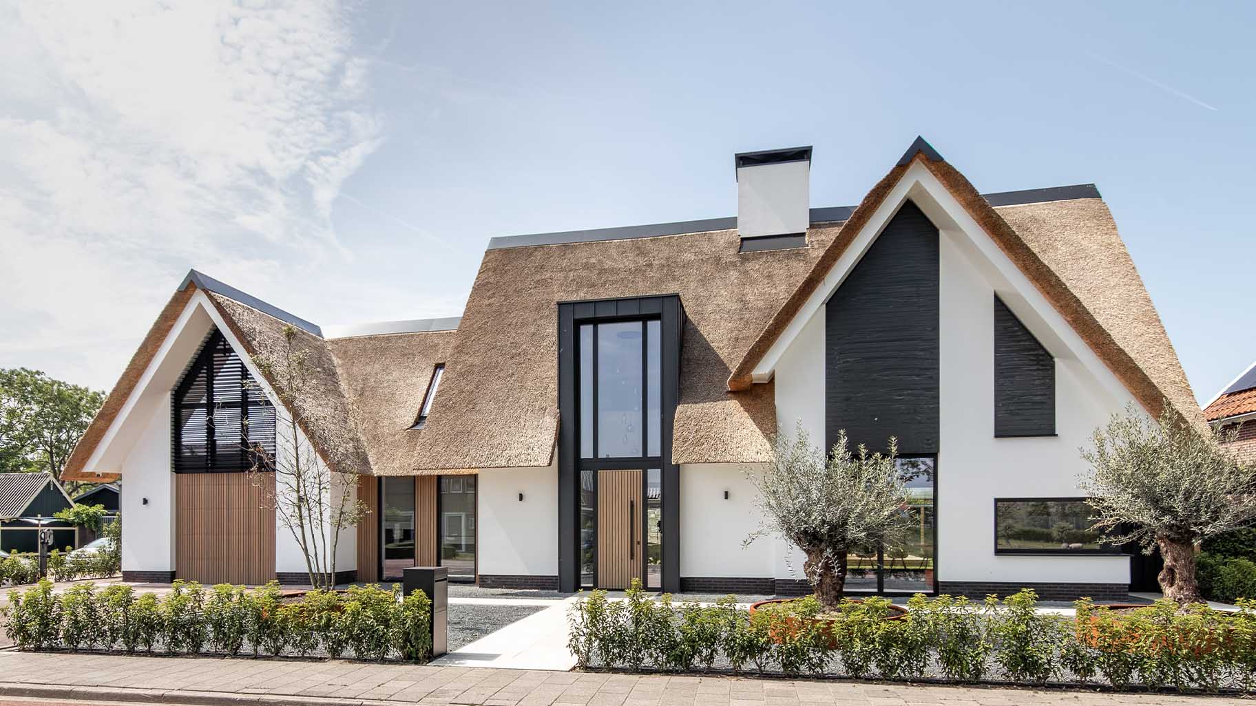 Custom garage door and front door with Afrormosia wooden slats for a new-build villa