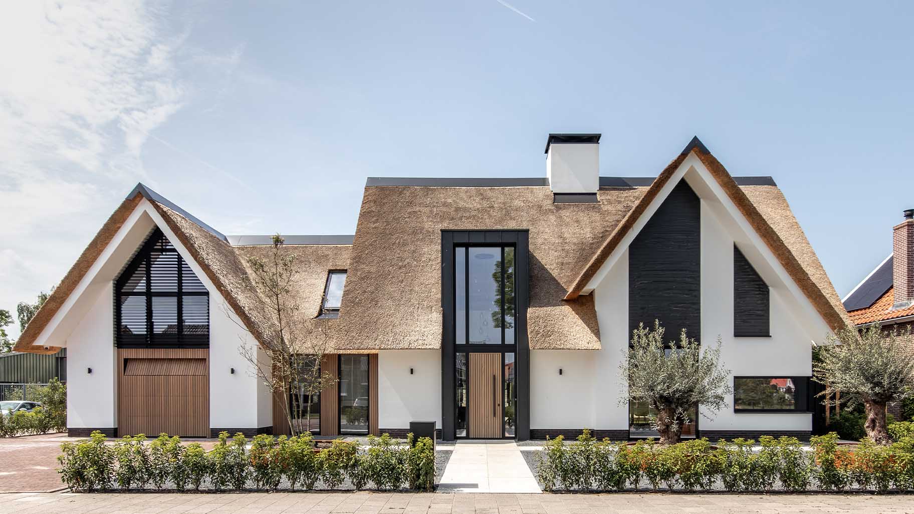 Custom garage door and front door with Afrormosia wooden slats for a new-build villa