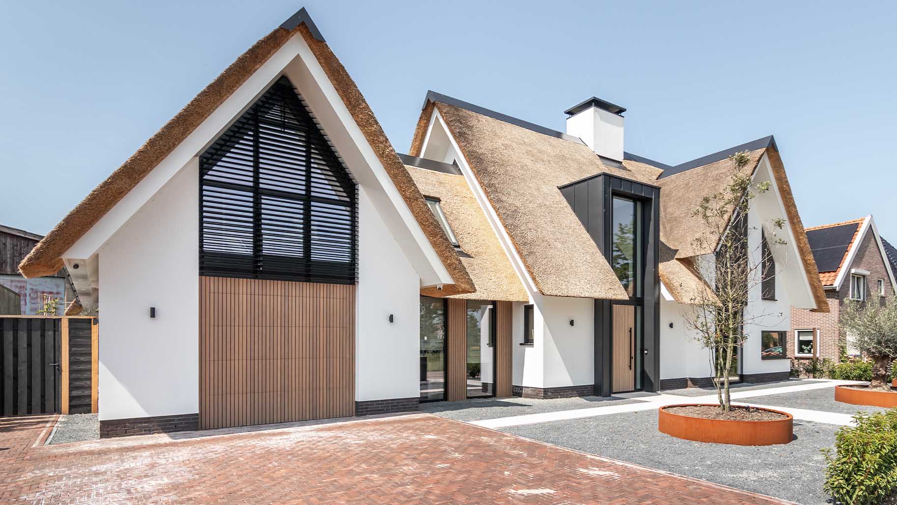 Custom garage door and front door with Afrormosia wooden slats for a new-build villa