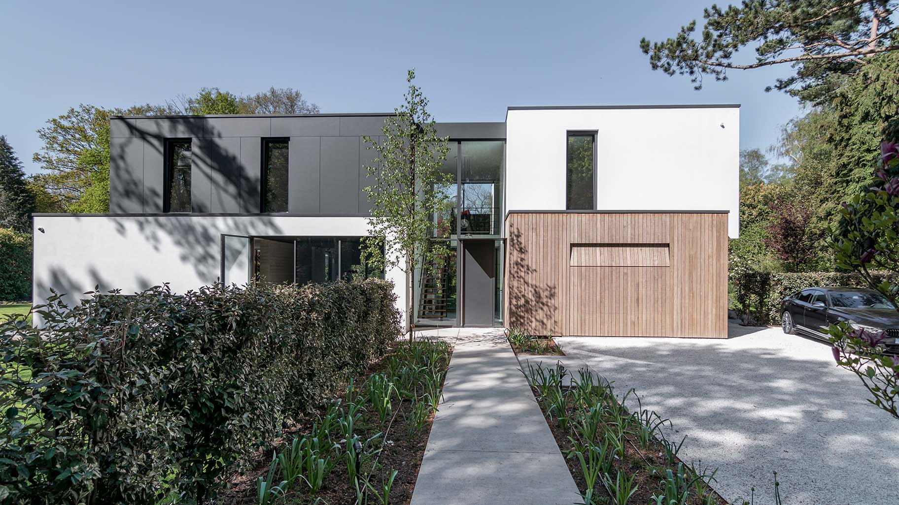 Wooden garage door that blends into the facade of a modern villa — Different Doors