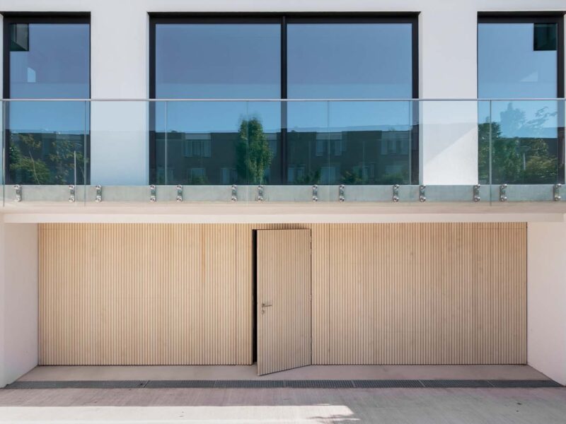 Wooden sectional doors with a wicket door made from Accoya wood - Different Doors