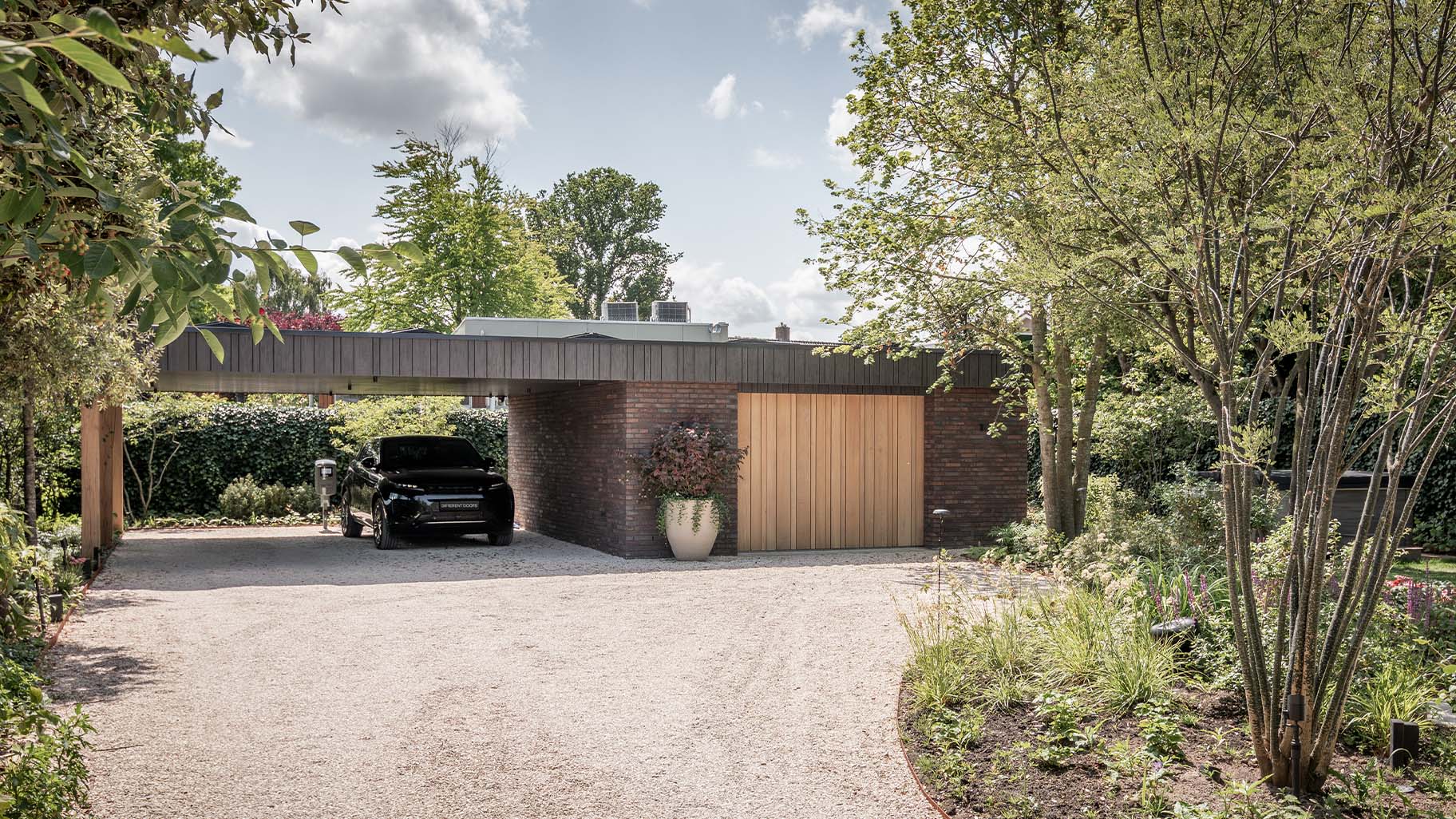 Oak side-opening garage door and pivot door in the same style - Different Doors