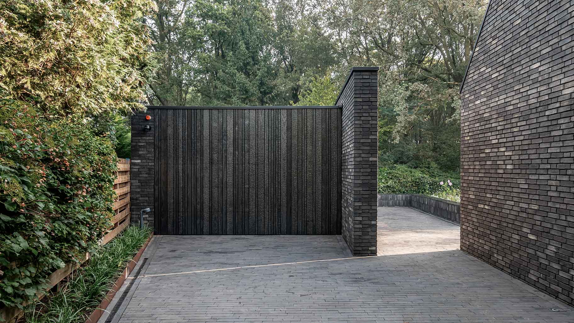 Wooden garage door made of Shou Sugi Ban (charred wood using a Japanese technique)