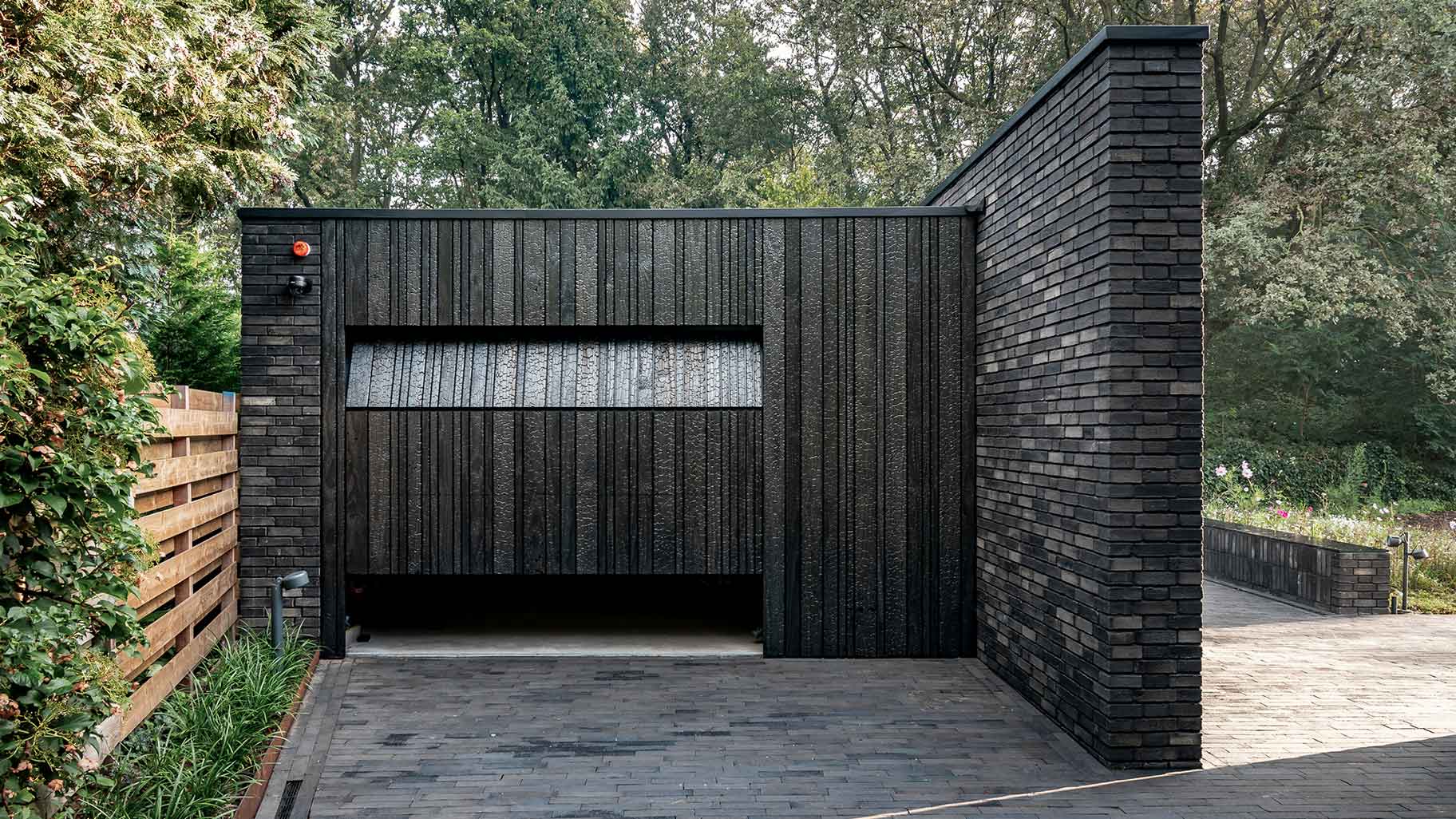 Wooden garage door made of Shou Sugi Ban (charred wood using a Japanese technique)