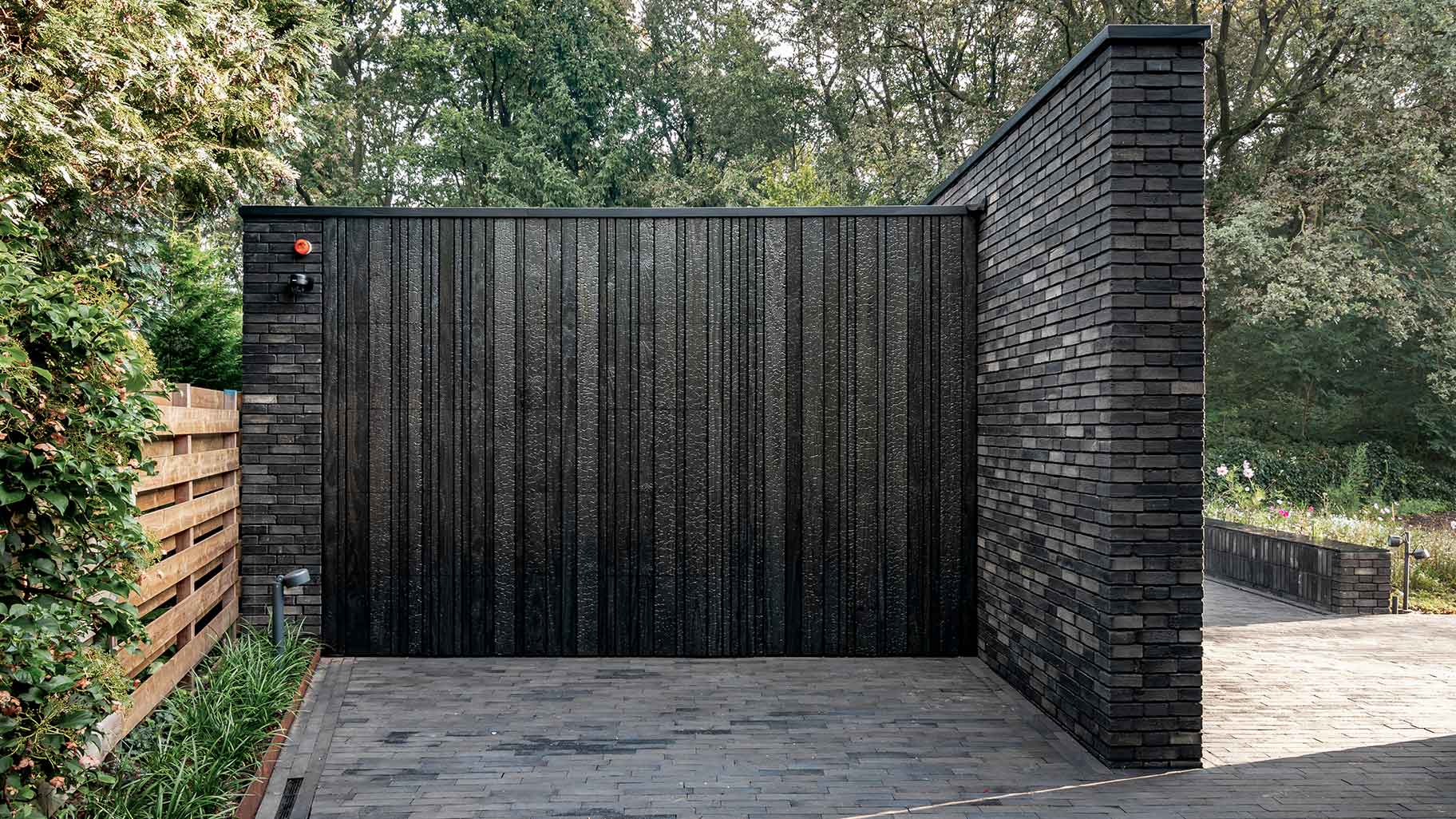 Wooden garage door made of Shou Sugi Ban (charred wood using a Japanese technique)