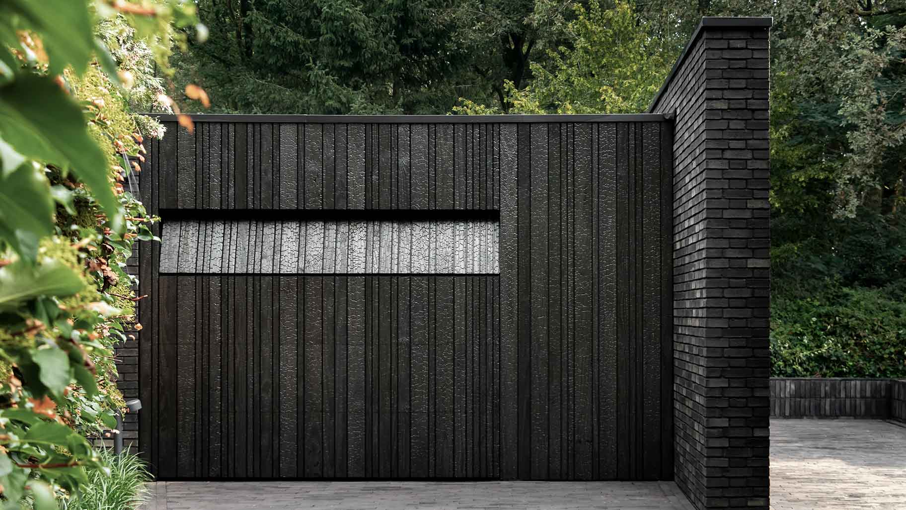 Wooden garage door made of Shou Sugi Ban (charred wood using a Japanese technique)
