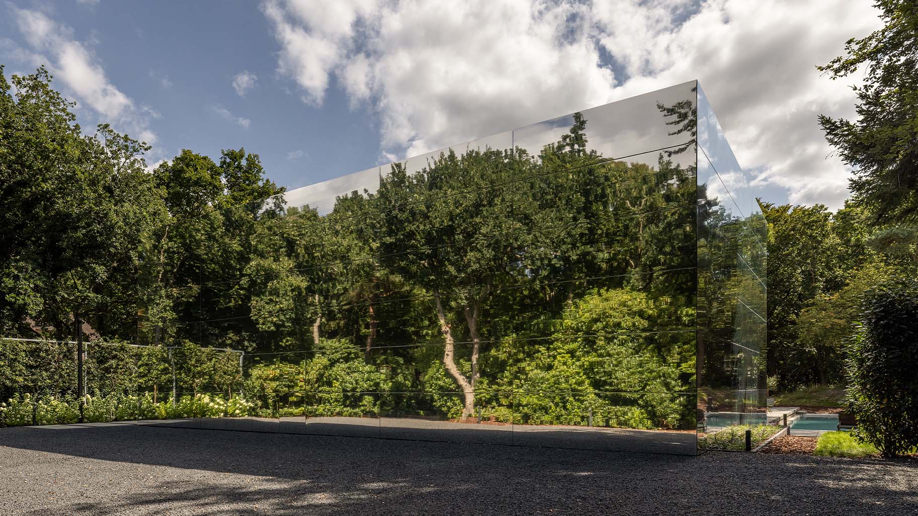Mirrored house with a garage door made of mirrors