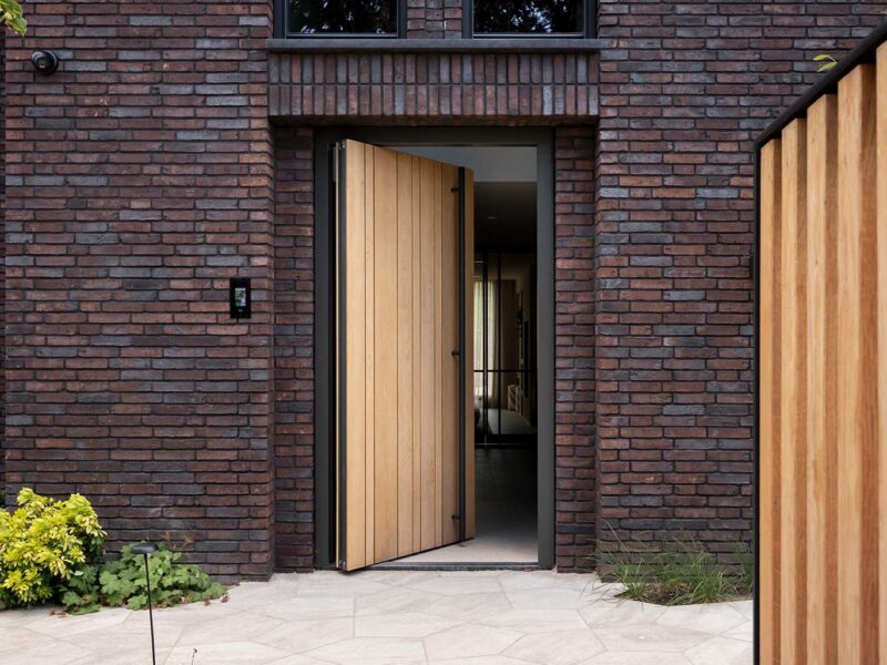 Oak side-opening garage door and pivot door in the same style - Different Doors