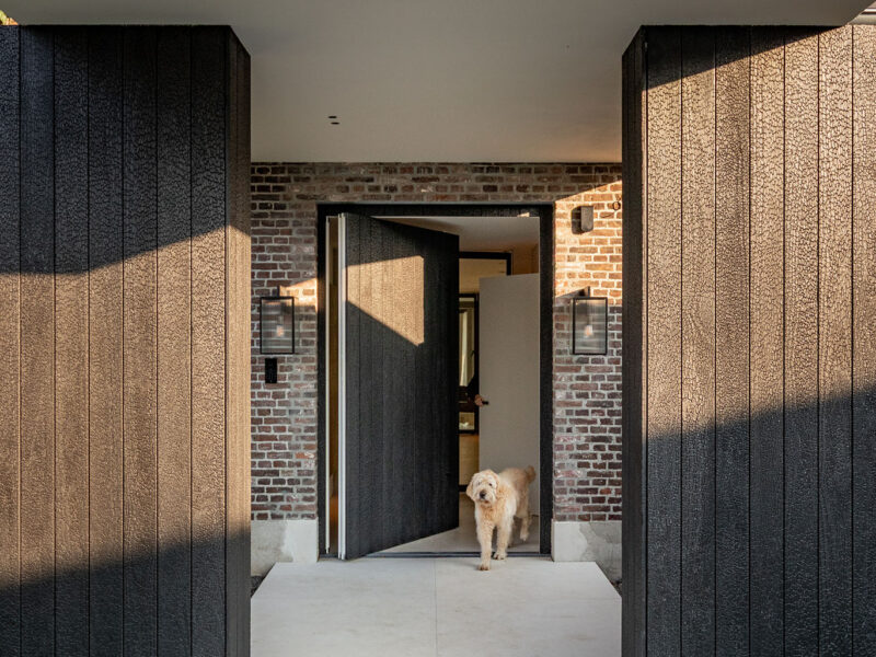 Pivot door as a front door made of Shou Sugi Ban wood