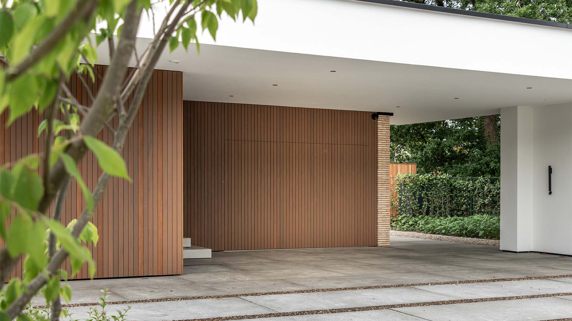 Side sliding garage door made of Fraké wood