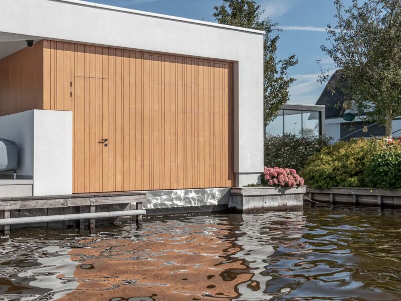 Bespoke garage door for a boathouse at a waterside villa
