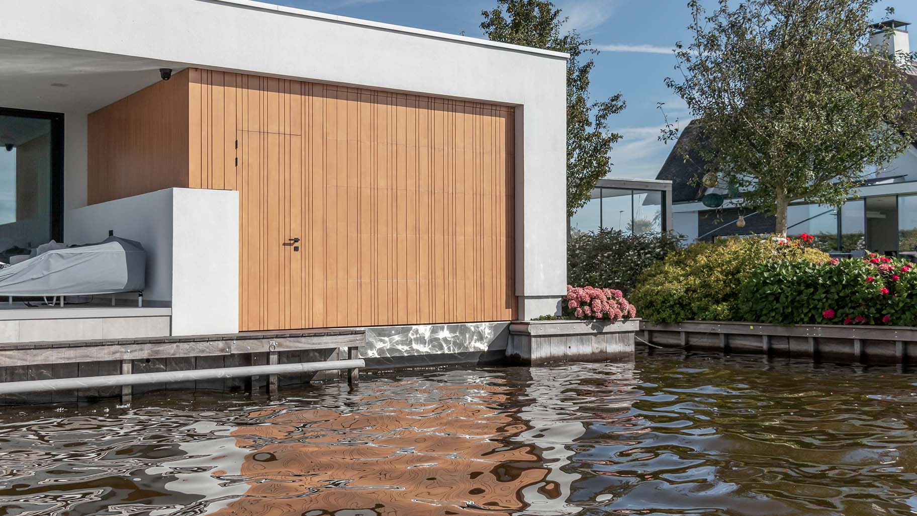 Bespoke garage door for a boathouse at a waterside villa