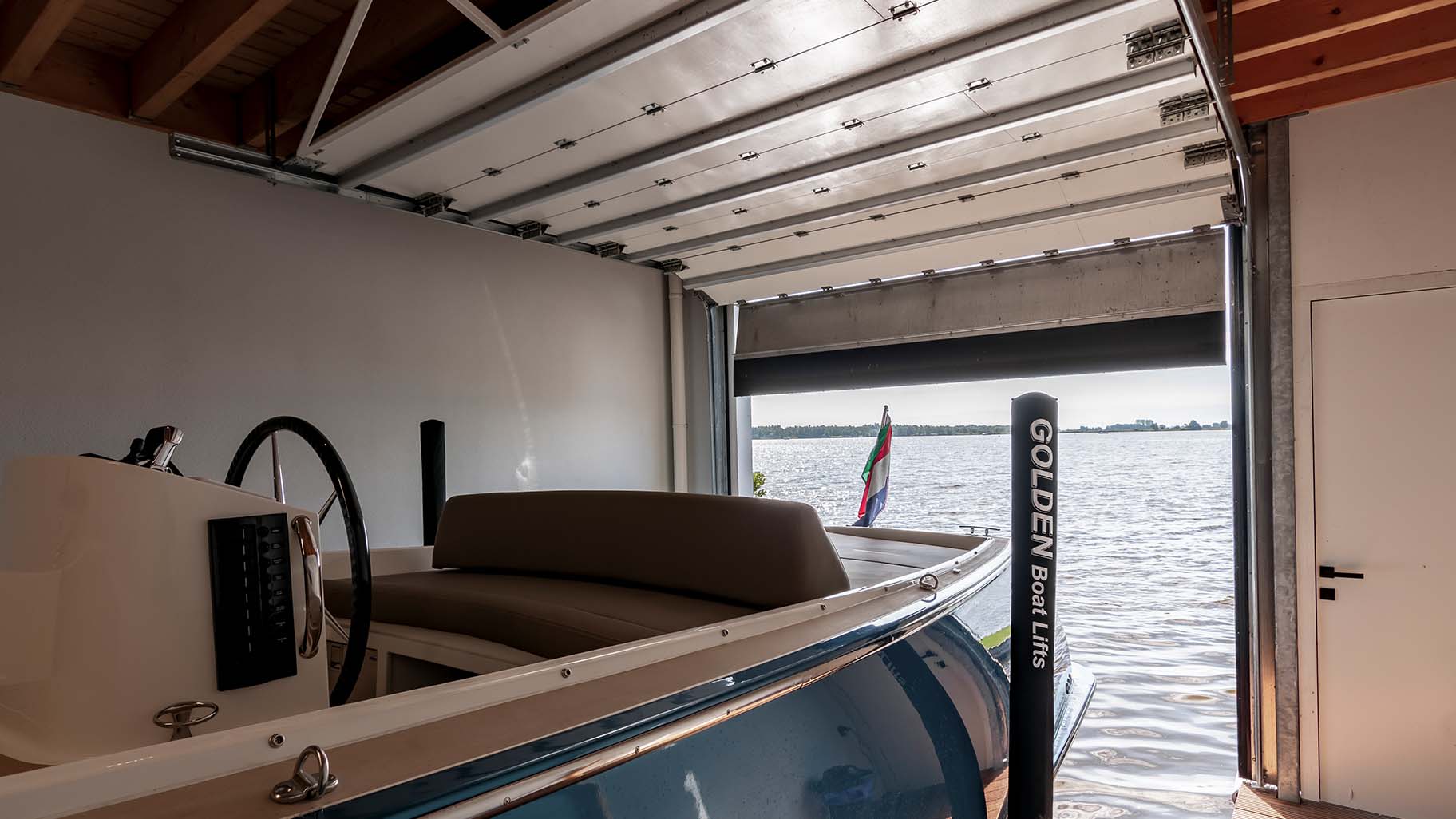 Bespoke garage door for a boathouse at a waterside villa