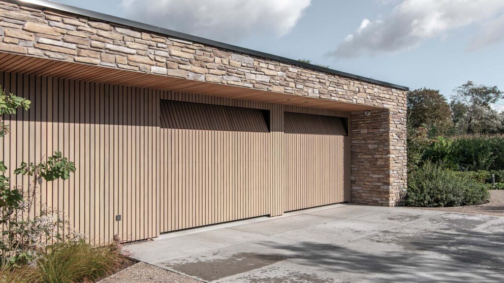 Wooden sectional doors clad with vertical Afrormosia slats - Different Doors
