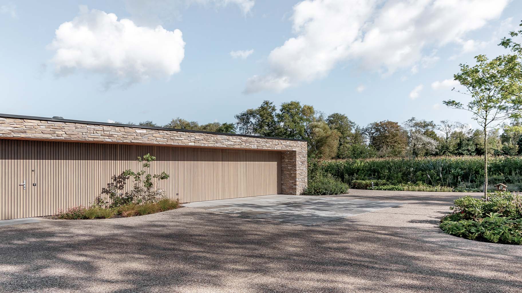 Wooden sectional doors clad with vertical Afrormosia slats - Different Doors
