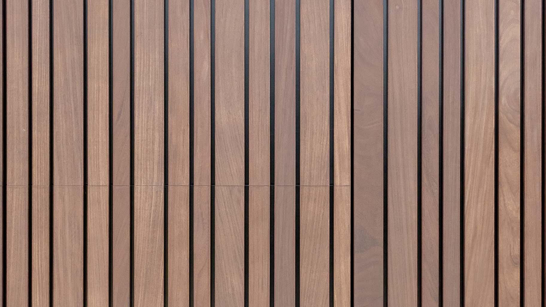 Invisible sectional garage door flush with facade - made from afrormosia