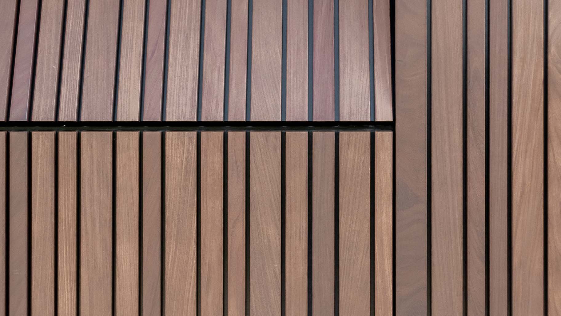 Invisible sectional garage door flush with facade - made from afrormosia